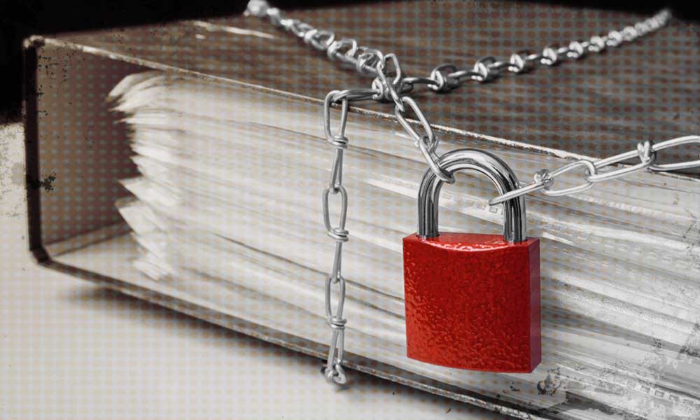 A book is wrapped in chains and secured with a red padlock, symbolizing privacy or the restricted access to information