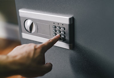 someone inputting a code to digital safe
