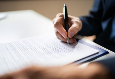 someone signing an estate plan document