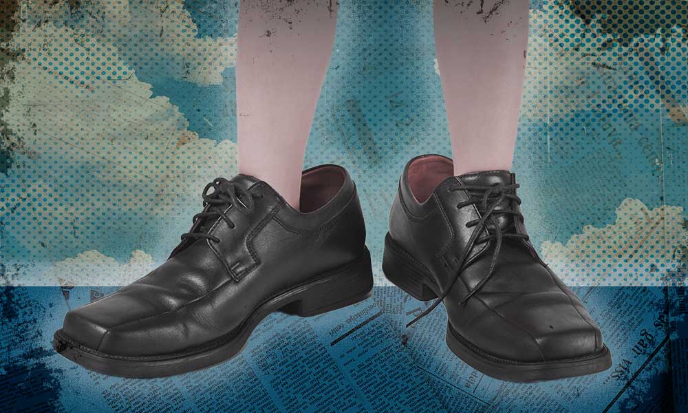 A person standing in oversized shoes, symbolizing the challenges and risks of inheriting business assets.