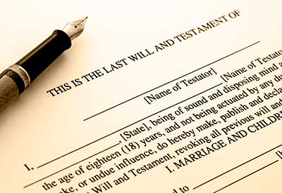 A close-up of a last will and testament form with a pen, highlighting estate planning and potential will contests.
