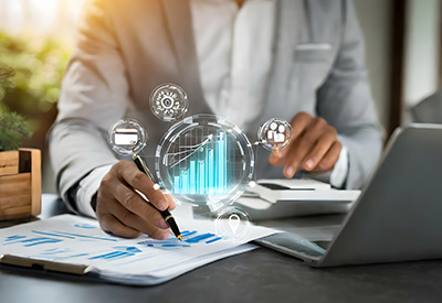 A business professional analyzes financial data and growth charts, utilizing digital tools for estate planning and asset management.