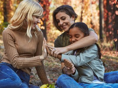 Estate Plan - Woman couple with daughter on Autumn day