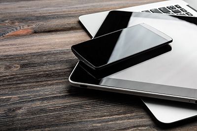 Digital Assets - Close up of a cell phone, tablet, and laptop computer
