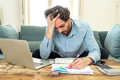 Life Estate - Stressed out middle-aged man reviewing documents