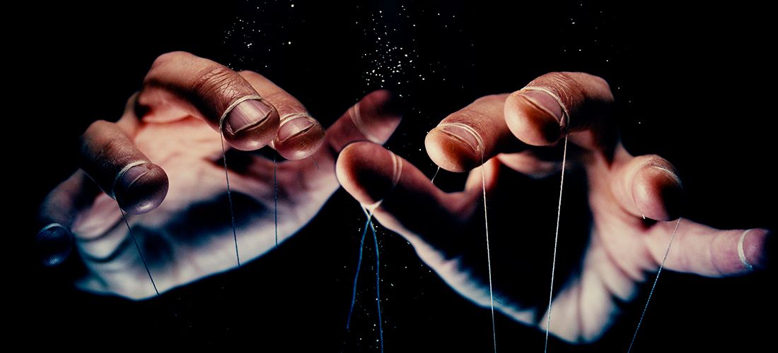Hands pulling strings