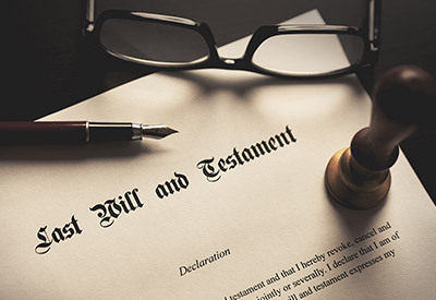 last will and testament document with a pen, glasses and notary seal