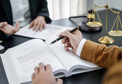 two people at a desk going over a will