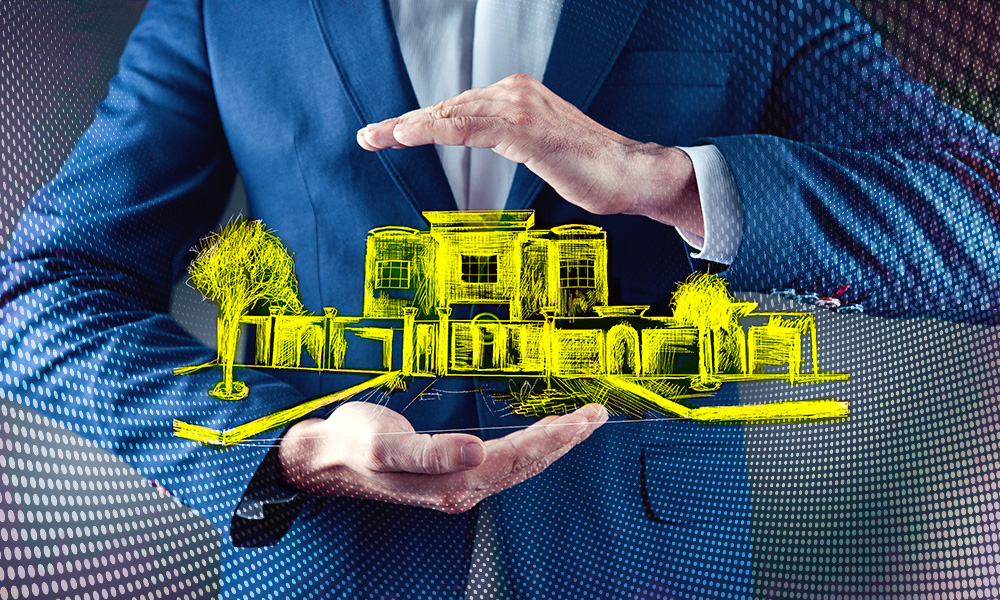 A man in a business suit cupping a glowing, holographic representation of a house and trees in his hands