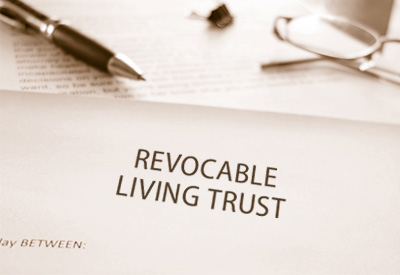 A revocable living trust document with a pen and reading glasses, representing estate planning and probate avoidance strategies.