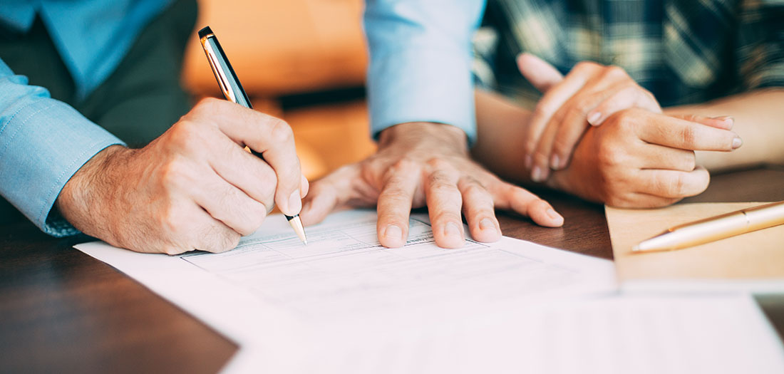 a couple signing a diy estate plan document
