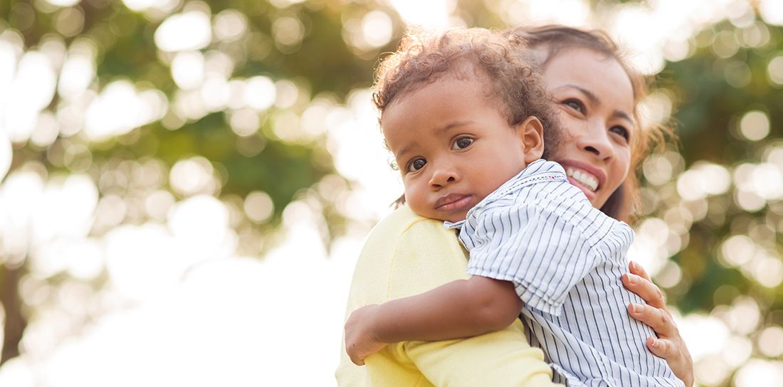 Mother holding her toddler son