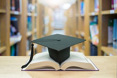 A graduation cap on top of a book