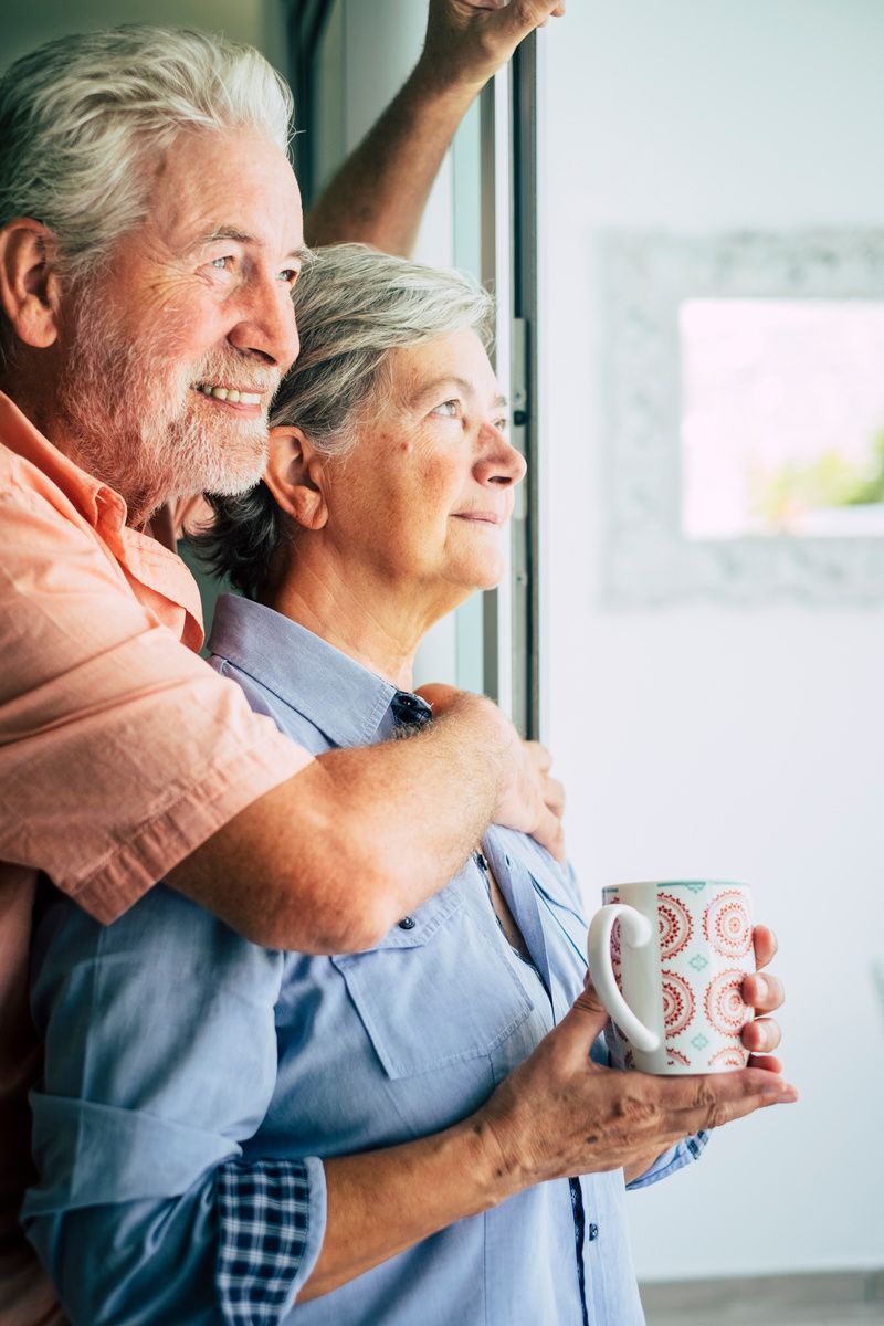 A senior couple looking outside together