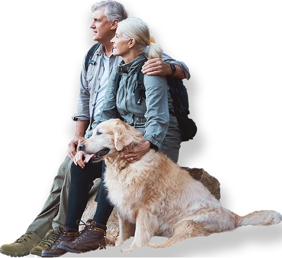couple with a dog in a forest