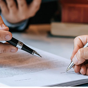 a hand signing a probate document