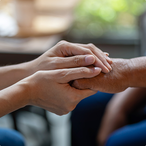 pair of hands holding another hand