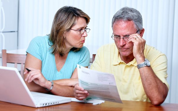 couple sitting and going over important planning documents